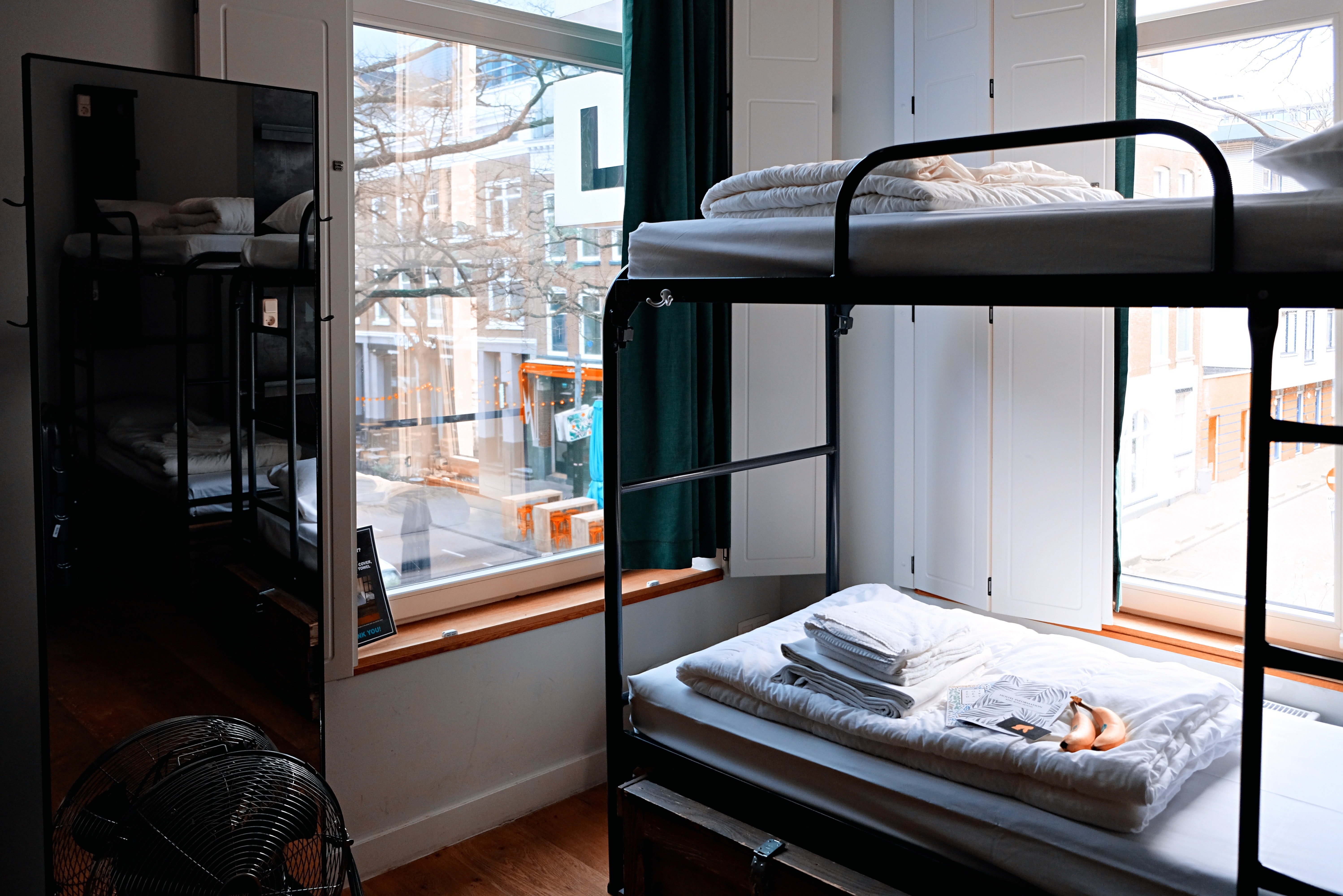 bunk beds in a room with large windows