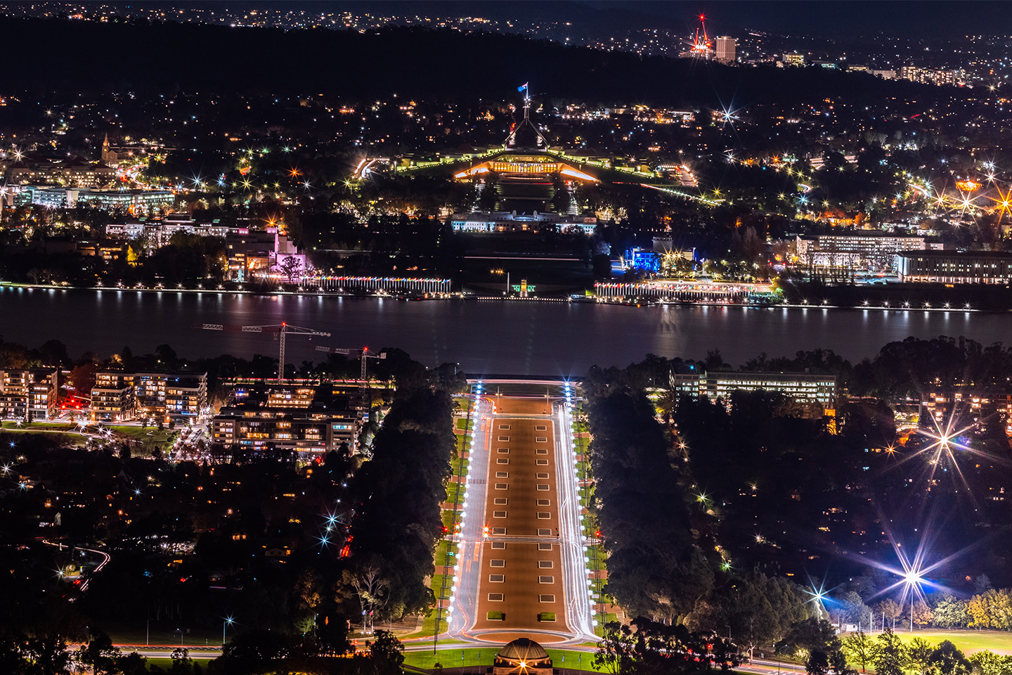 Aerial photo of Canberra city at night with lots of lights on