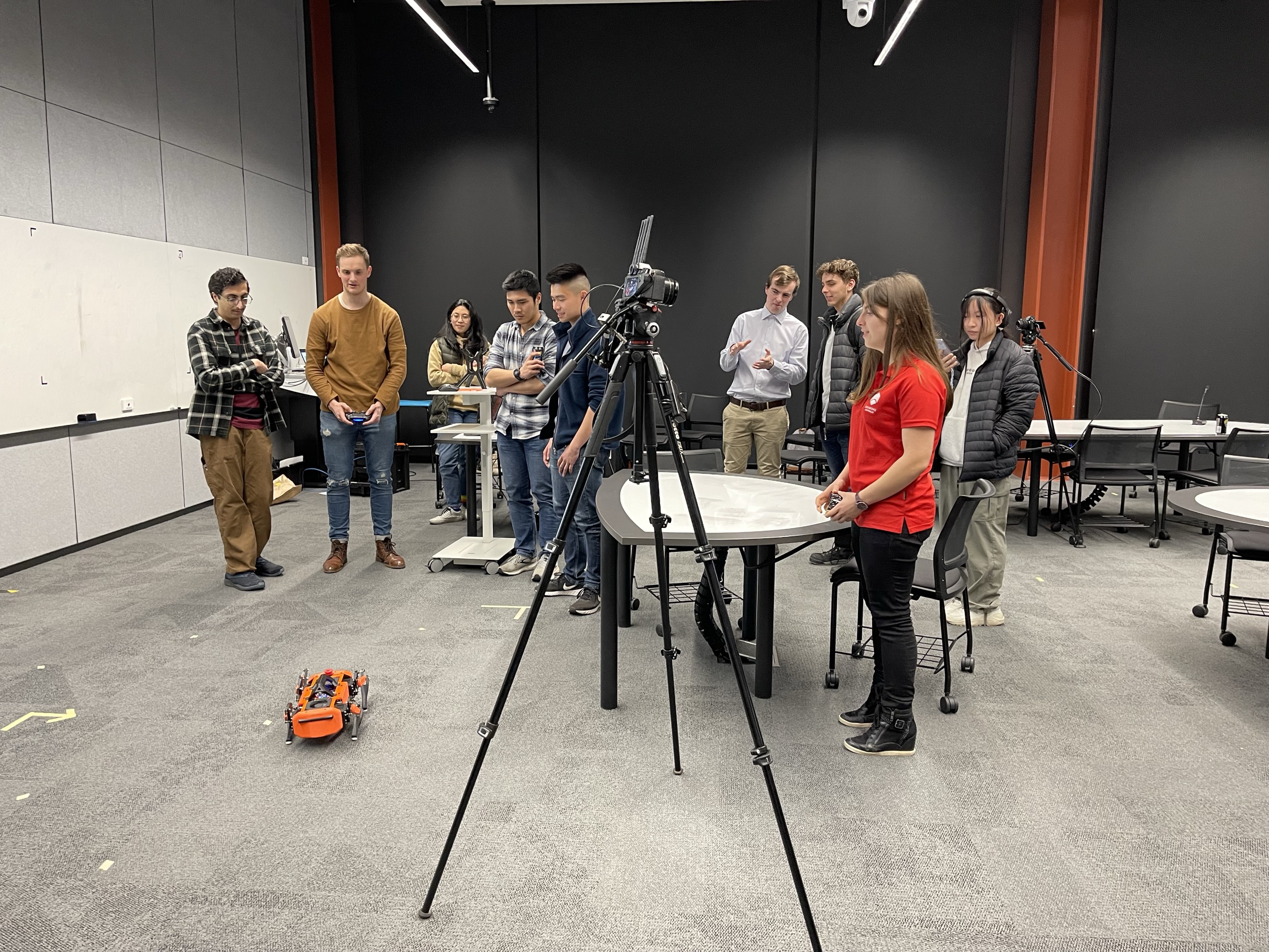 Image of young engineers together playing with a robot