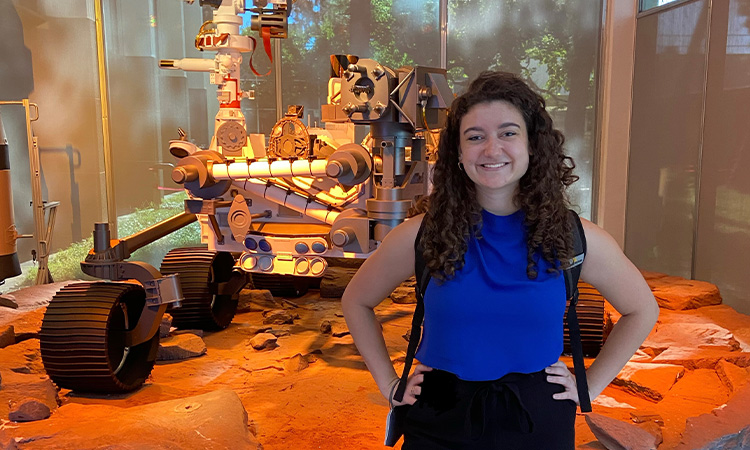Engineering student Tully Mahr with a Mars Rover